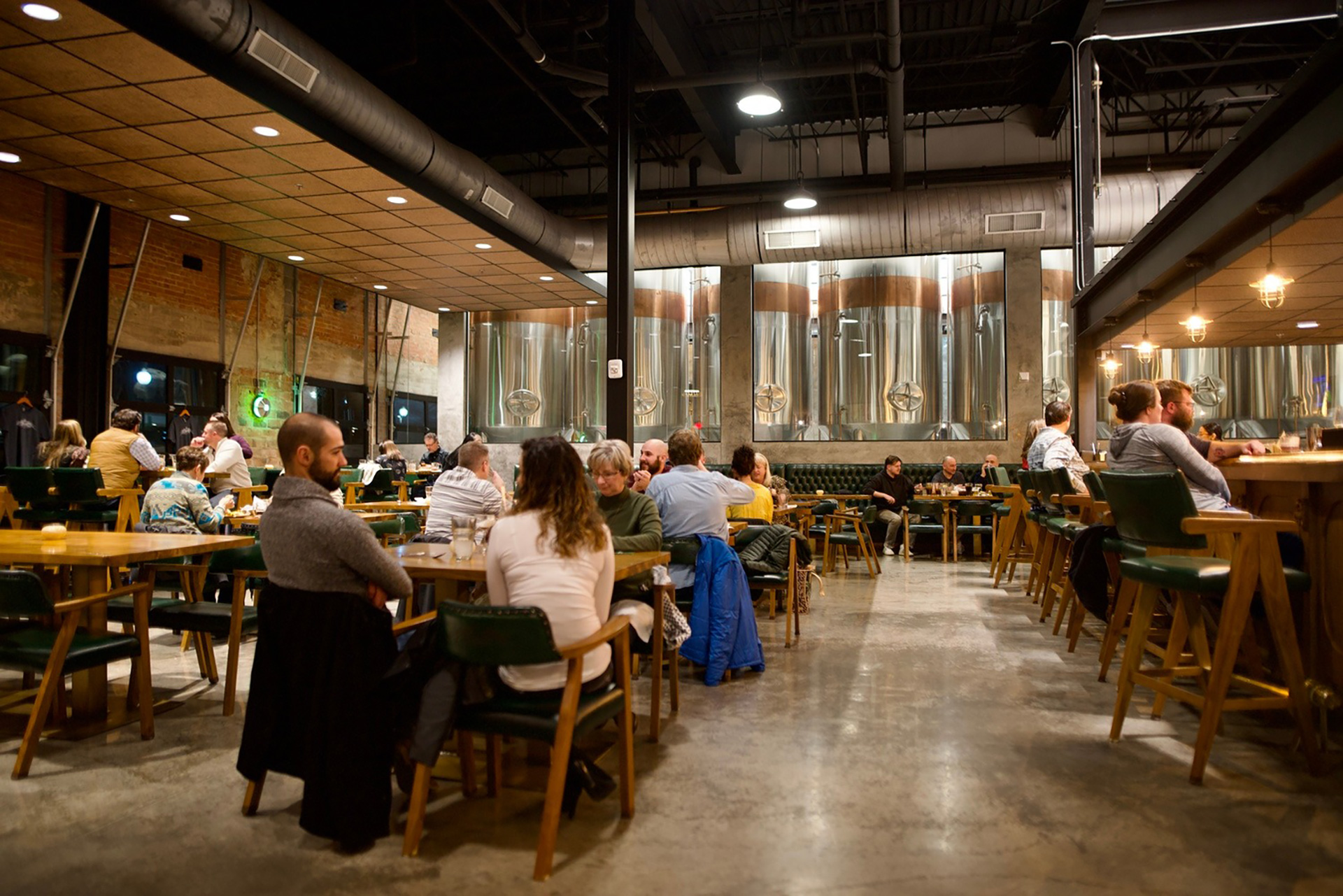 Pivovar Dining area with guests showing vats